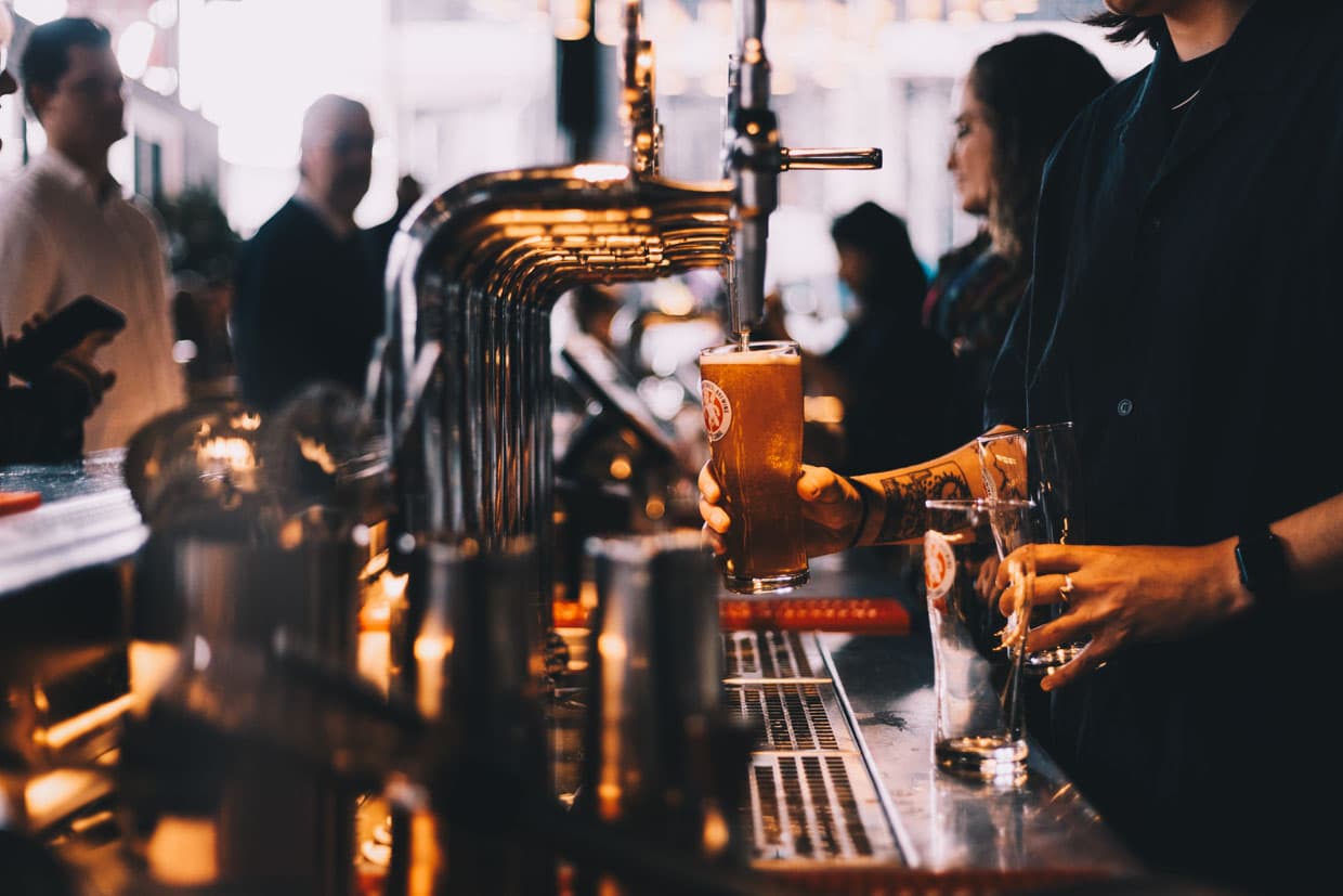 Bartender pouring a pint of craft beer at the taps at The Bellman, Merchant City Glasgow